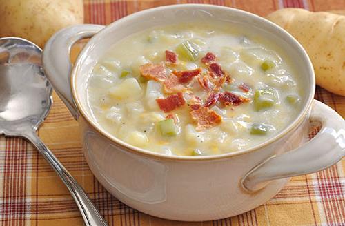 bacon bits on potato soup in white bowl